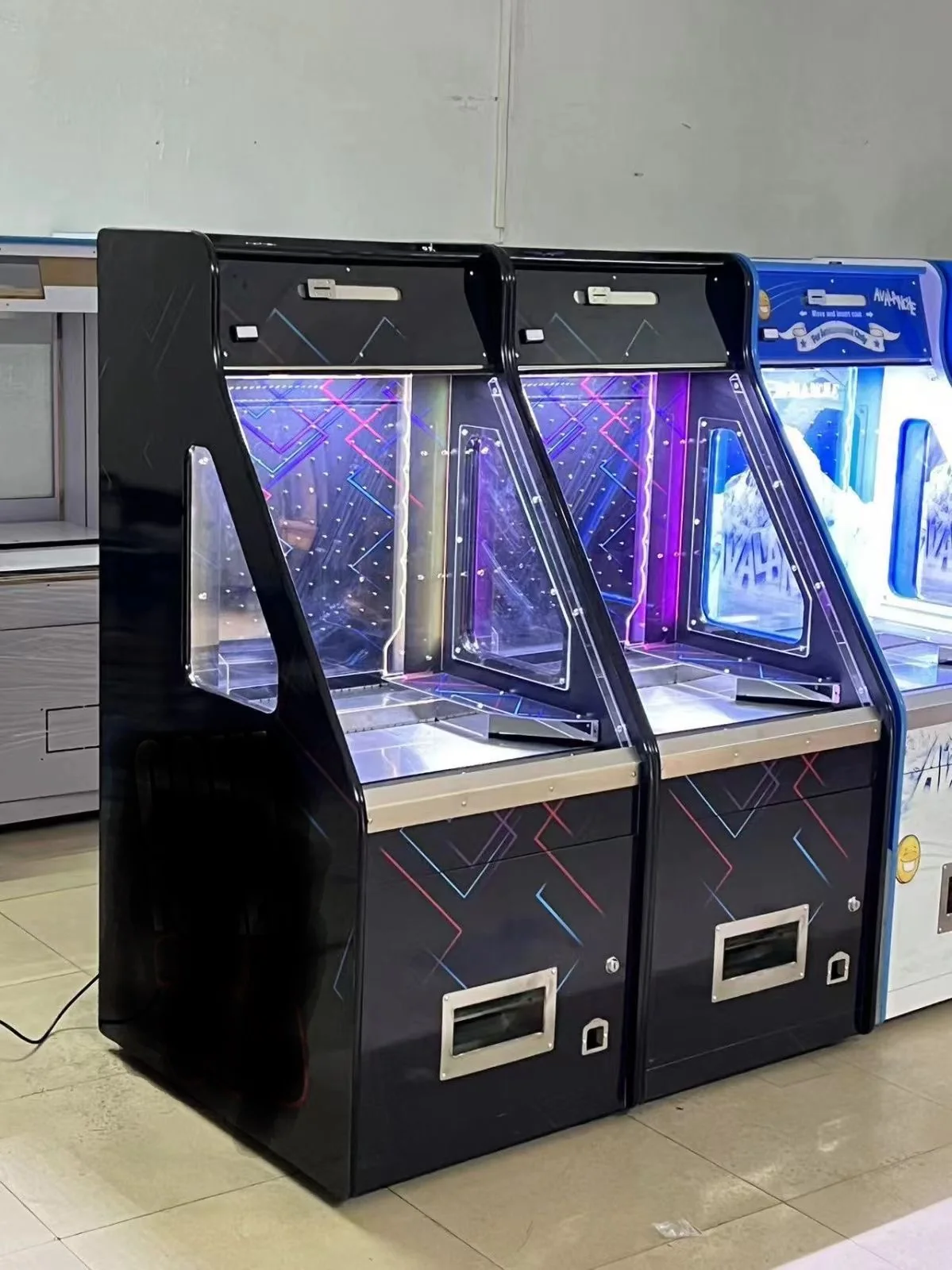 Angled view of a commercial coin pusher cabinet