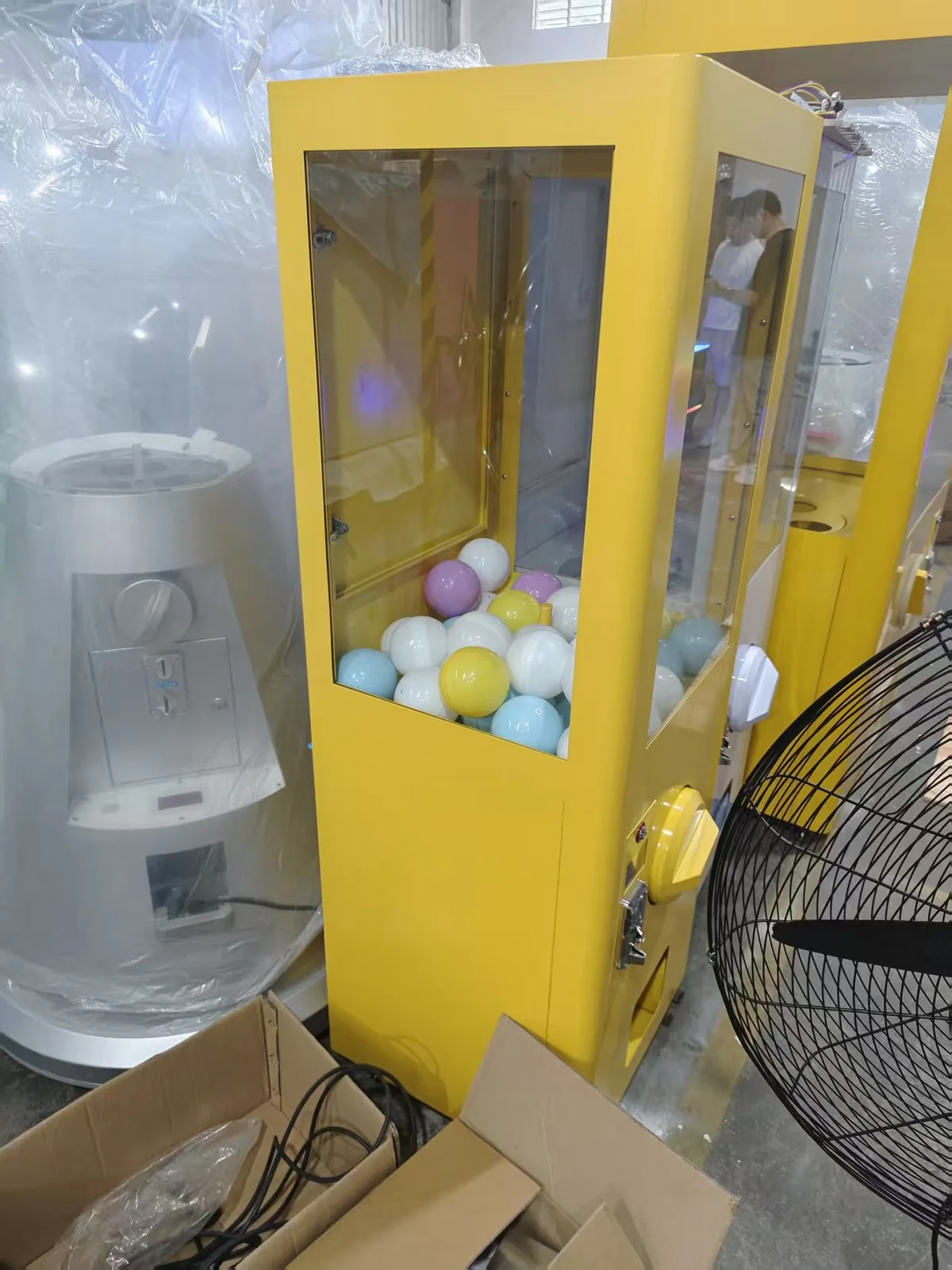 Yellow giant capsule vending machine loaded with capsules
