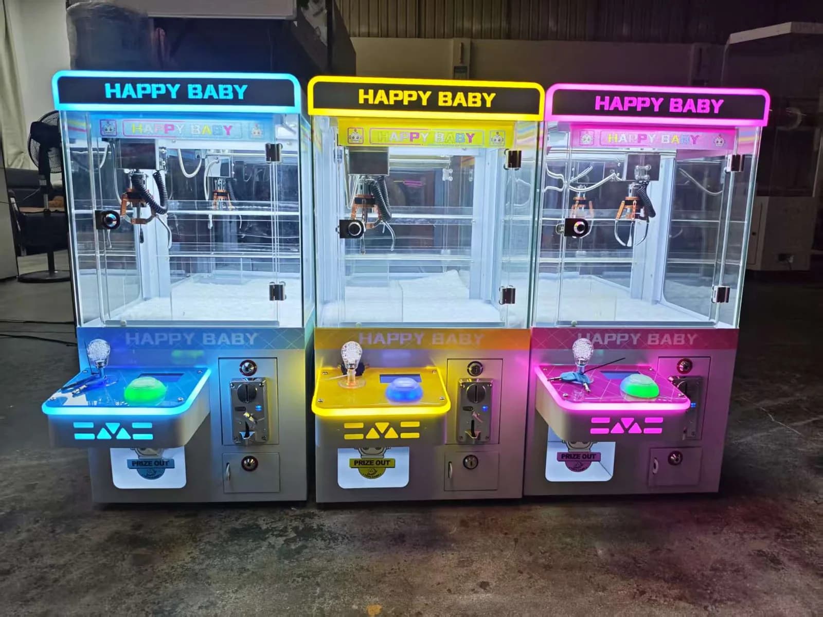 Mini claw machines in blue yellow and pink colors